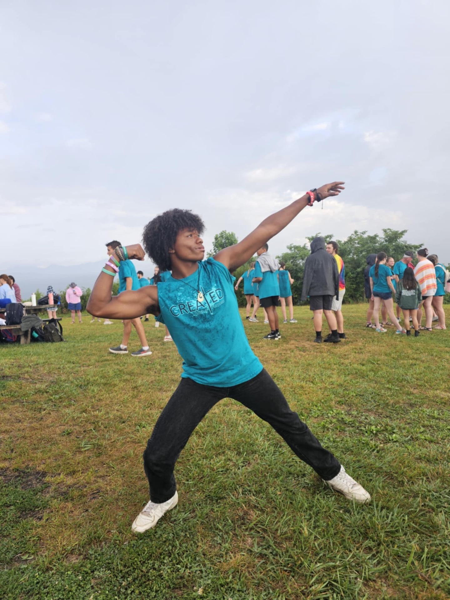 A student striking a pose during a camp gathering