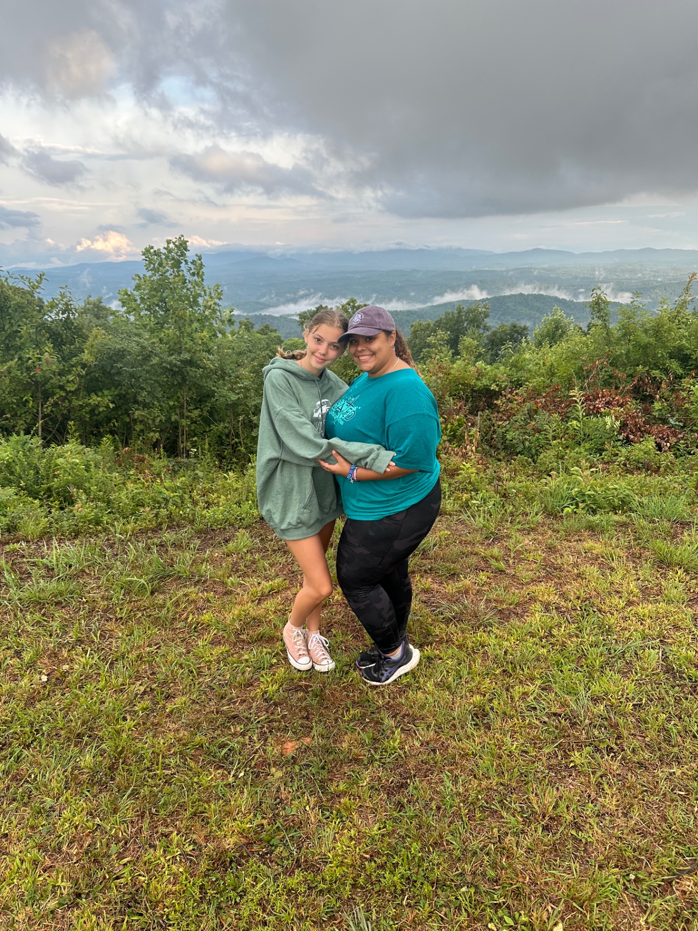 A leader and a student together on the ridge at camp