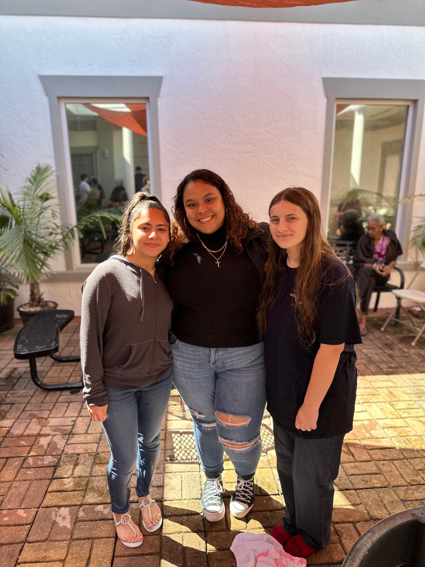 Three students together in the courtyard