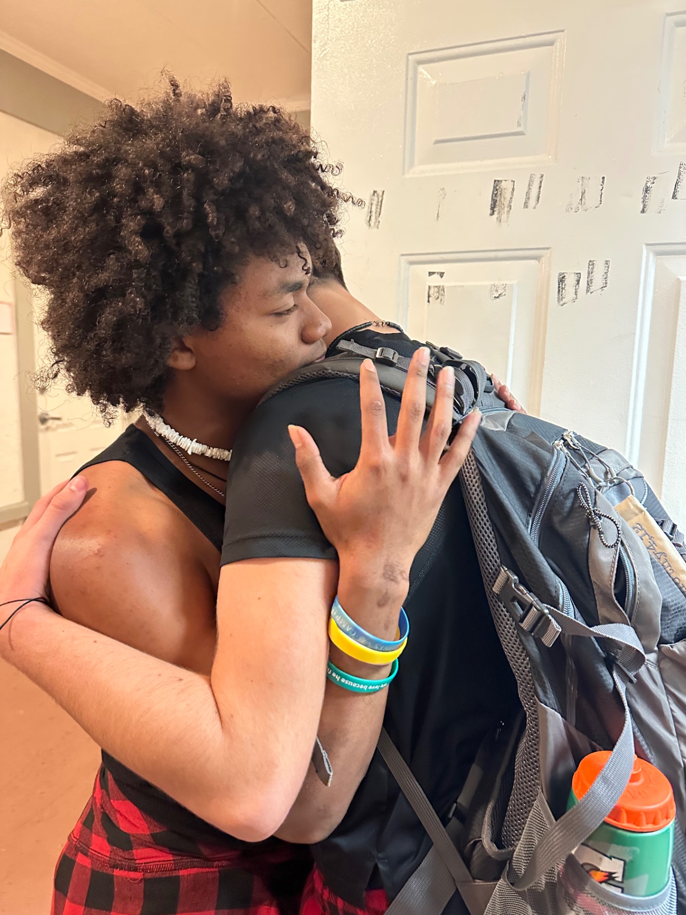 Two students hugging goodbye after a trip